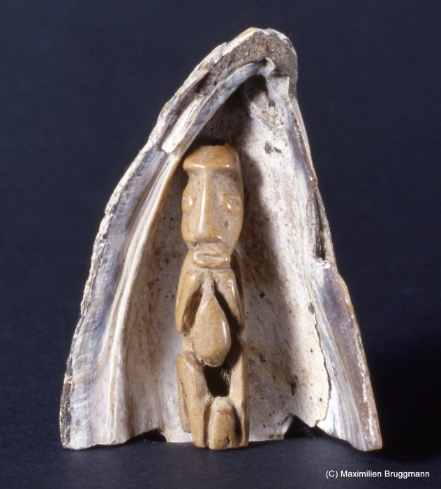 The idea that the first humans lived in a shell is a frequently recurring theme in the various creation myths of the Northwest Coast Indians. This small bone figure, 41 mm (2 inches) high, was dug up together with its protecting shell at Ozette, the archaeological site on the Olympic Peninsula. It is on exhibit at the Makah Museum