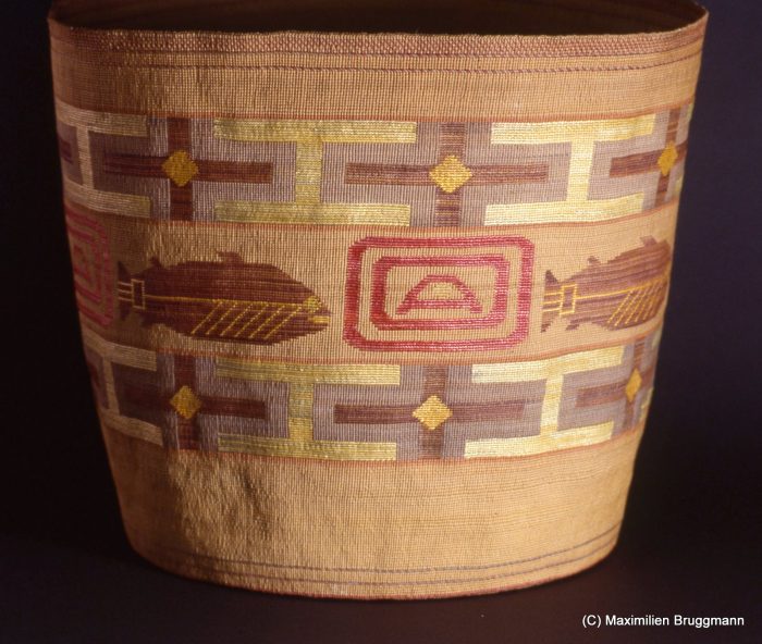 21 This basket, collected around die turn of the century, is a stunning example. It is woven of spruce roots and multicolored grasses. The blue color is created with huckleberries. (38 cm; ASM)